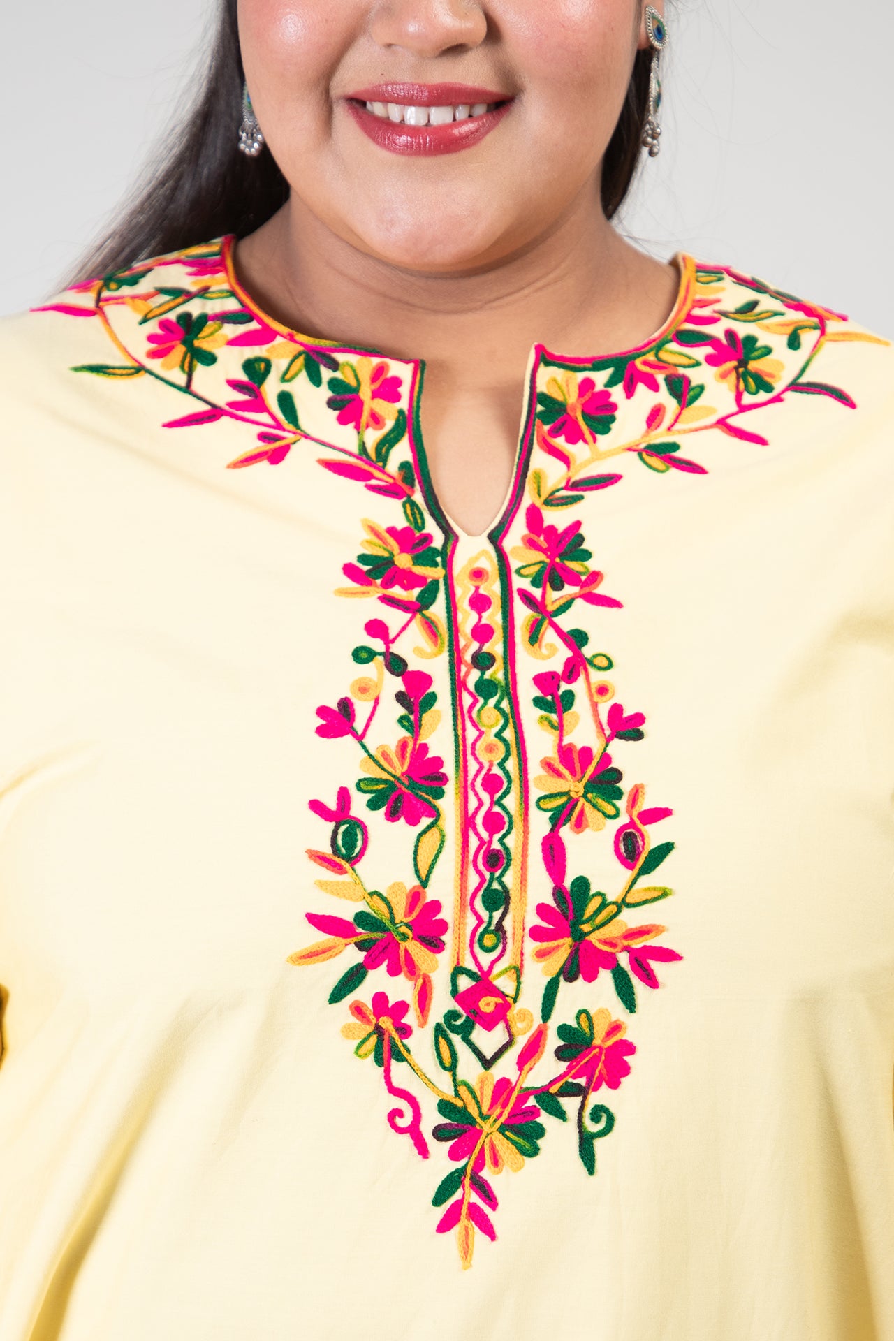 Yellow Coloured Premium Kashmiri Long cotton Kurti Styled with small U-slit cut at Front and Graced with Double shaded Multi Colour Floral Aari Work embroidery.