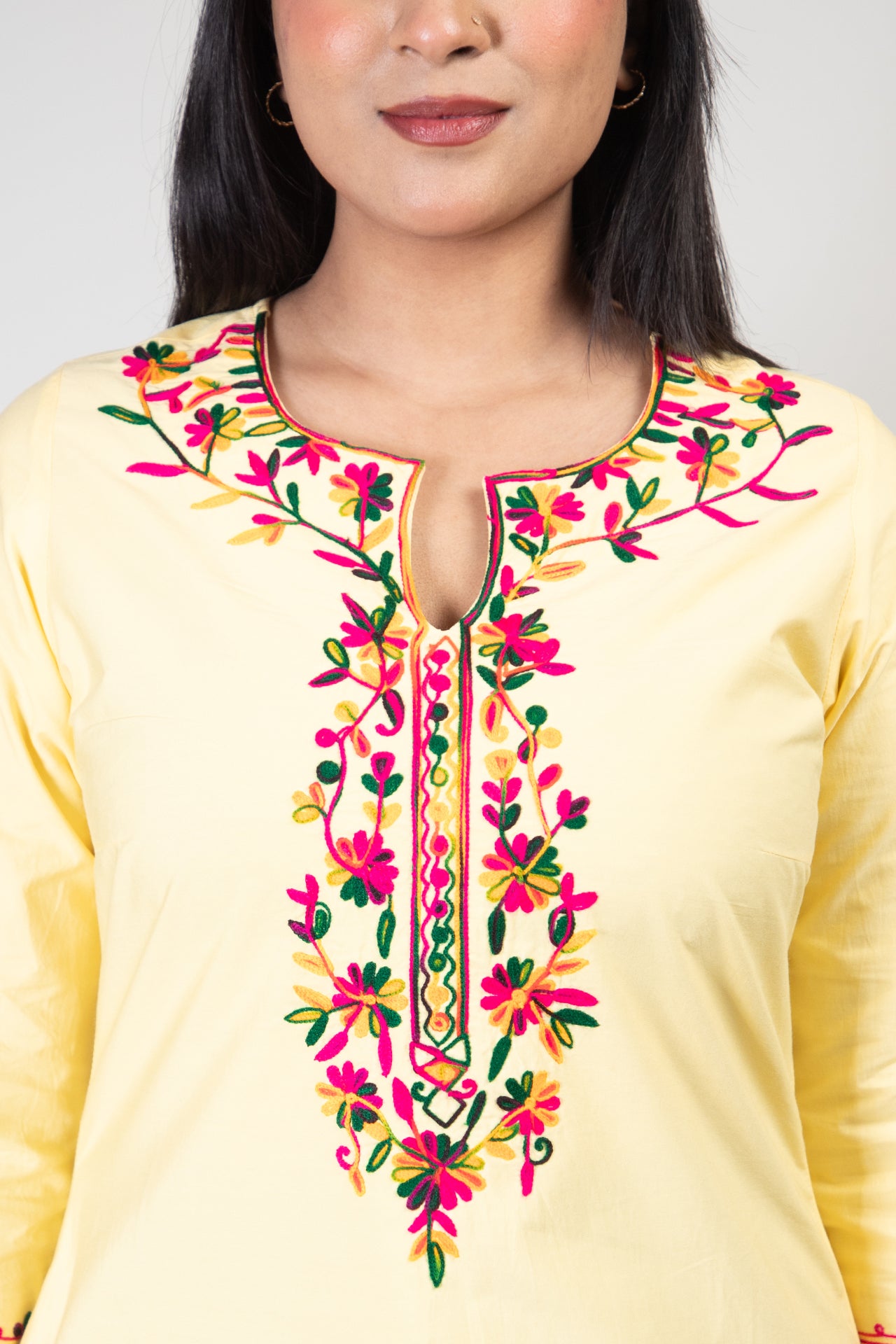 Yellow Premium Kashmiri Short cotton Kurti Styled with small U-slit cut at front and graced with Multi colour Floral Aari Work embroidery