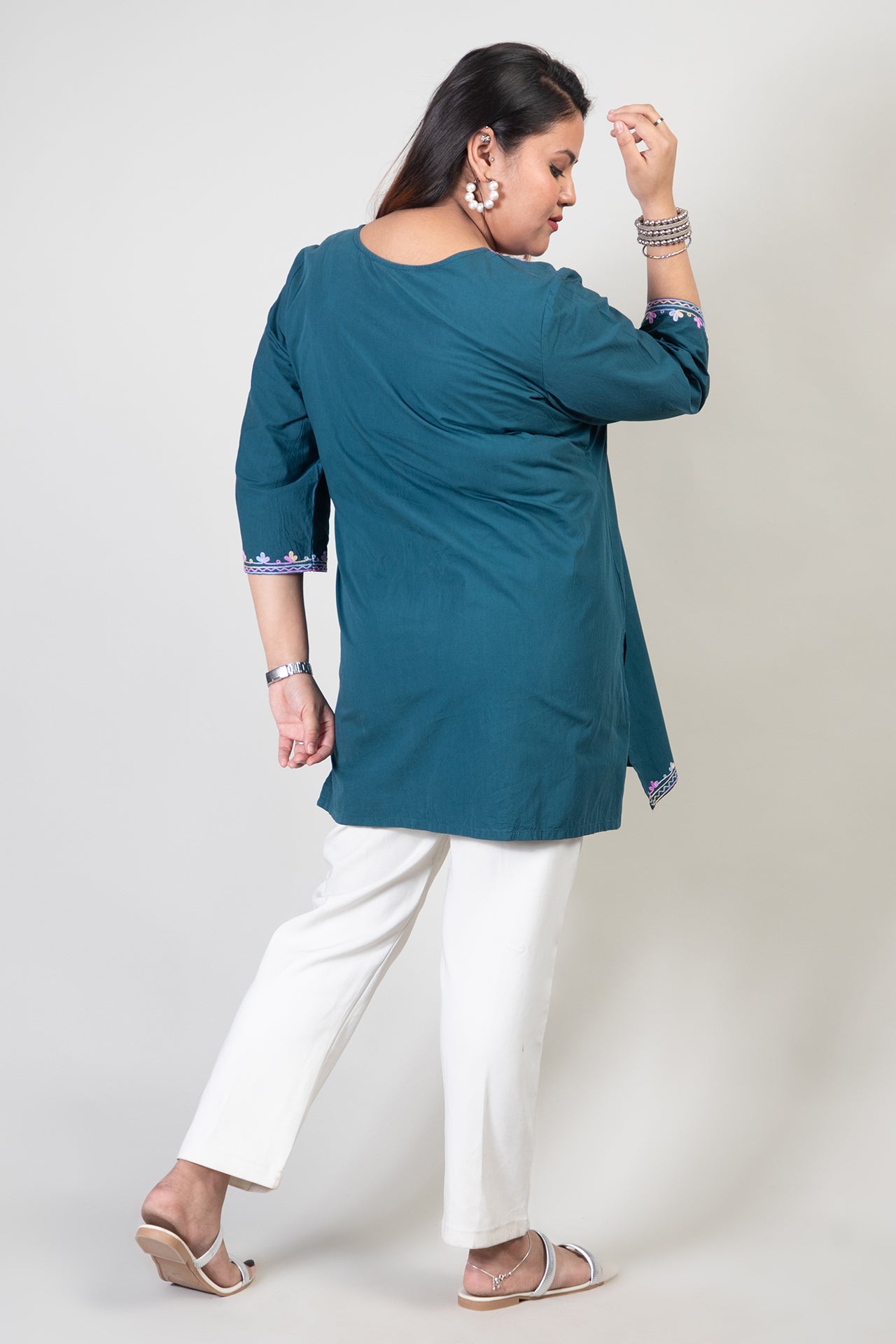 Teal Green Coloured Premium Kashmiri Short cotton Kurti Styled with small V-slit cut at Front and graced with Double shaded Multi Colour Floral Aari Work embroidery