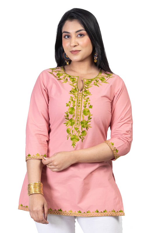 Peach Coloured Premium Kashmiri Short cotton Kurti Styled with small U-slit cut at Front and Graced with Double shaded Green Floral Aari Work embroidery.