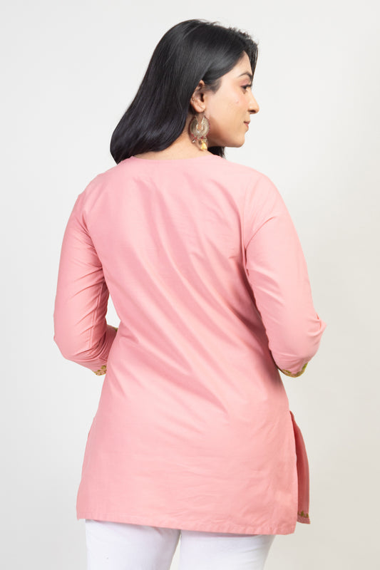 Peach Coloured Premium Kashmiri Short cotton Kurti Styled with small U-slit cut at Front and Graced with Double shaded Green Floral Aari Work embroidery.