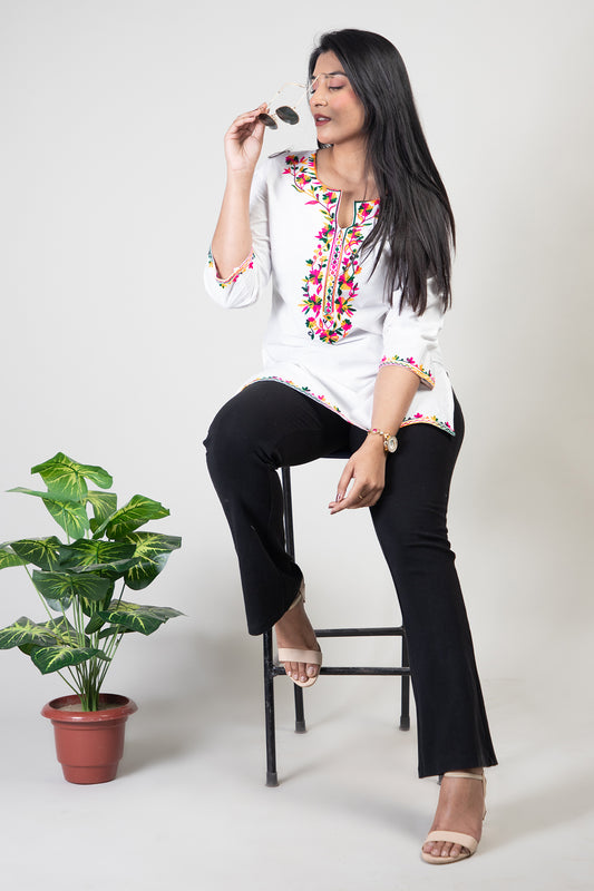 White Premium Kashmiri Short cotton Kurti Styled with small U-slit cut at front and graced with Double shaded Multi colour Floral Aari Work embroidery