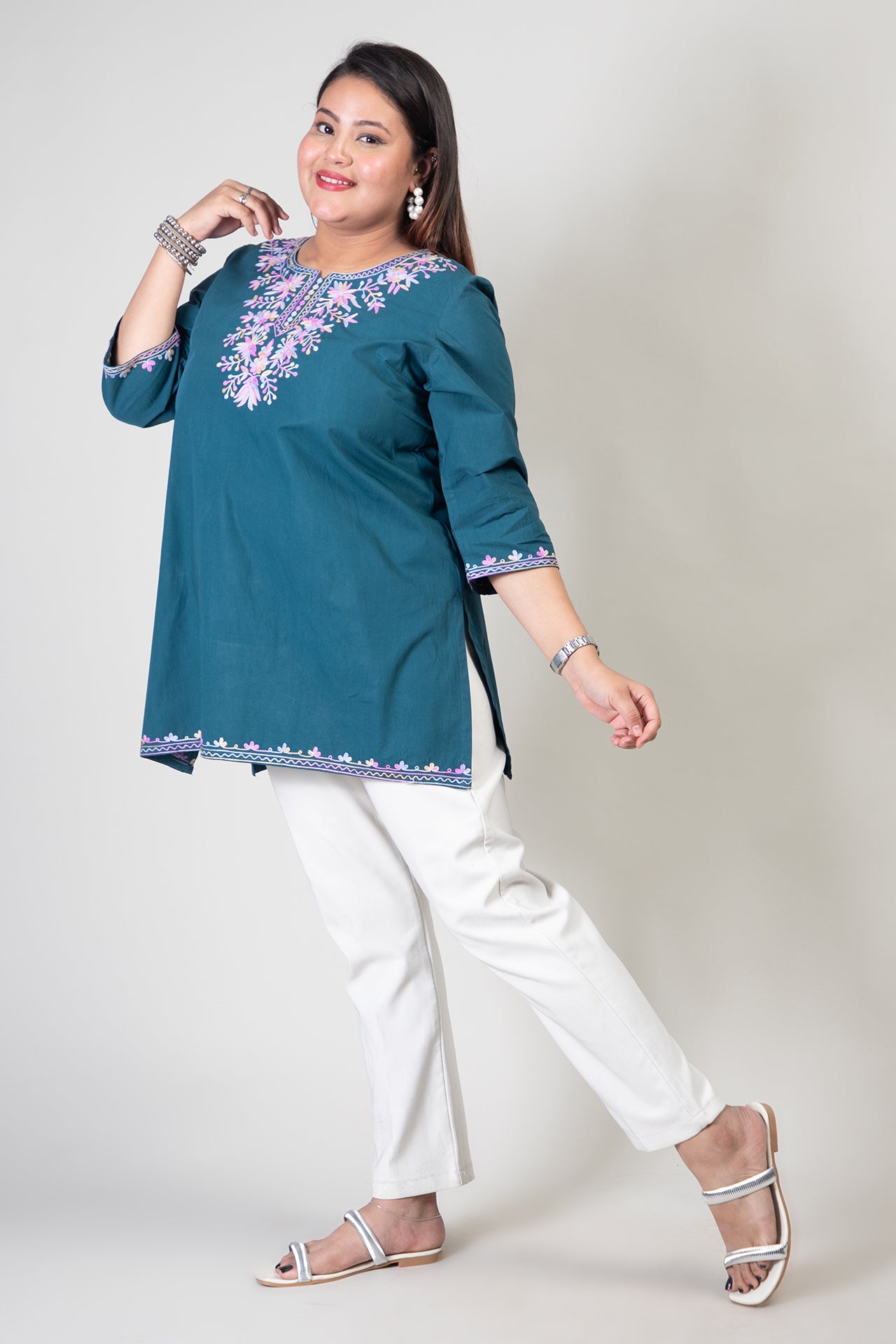 Teal Green Coloured Premium Kashmiri Short cotton Kurti Styled with small V-slit cut at Front and graced with Double shaded Multi Colour Floral Aari Work embroidery