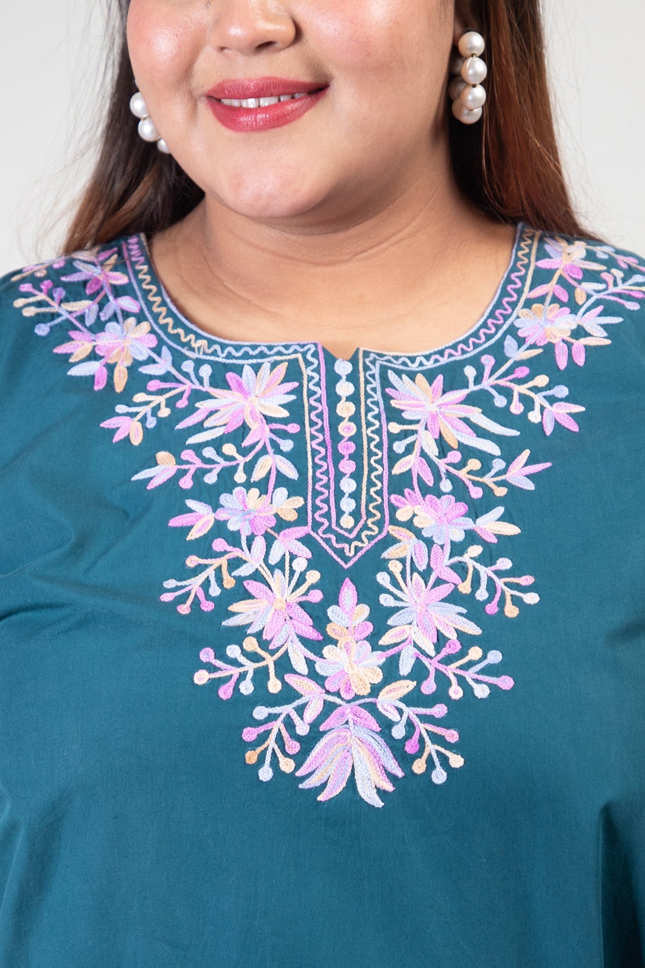 Teal Green Coloured Premium Kashmiri Short cotton Kurti Styled with small V-slit cut at Front and graced with Double shaded Multi Colour Floral Aari Work embroidery